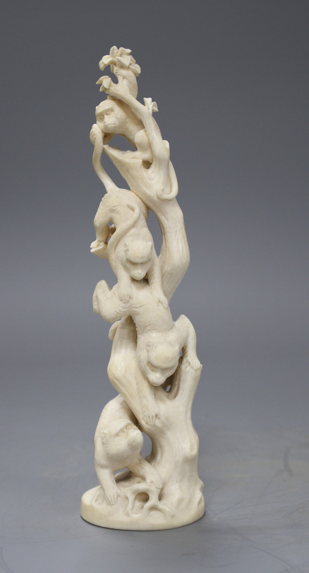 A Japanese Meiji period Tokyo School okimono carved with monkeys climbing a tree, unsigned, height 21.5cm